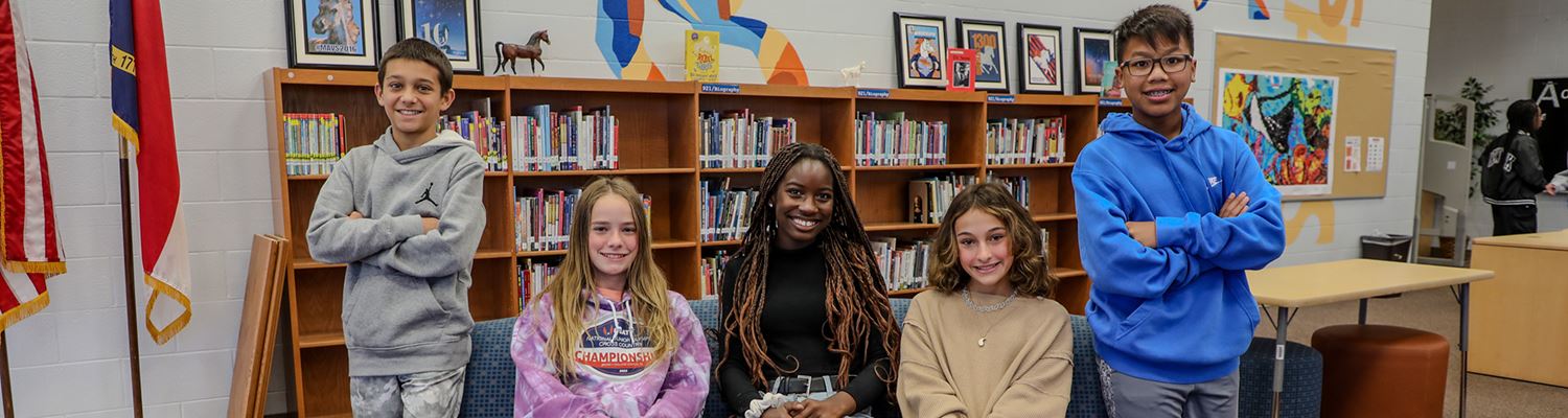 Group of Marvin Ridge Middle students smiling in the media center